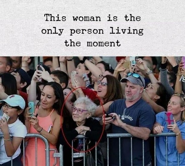 This woman is the only person living the moment.