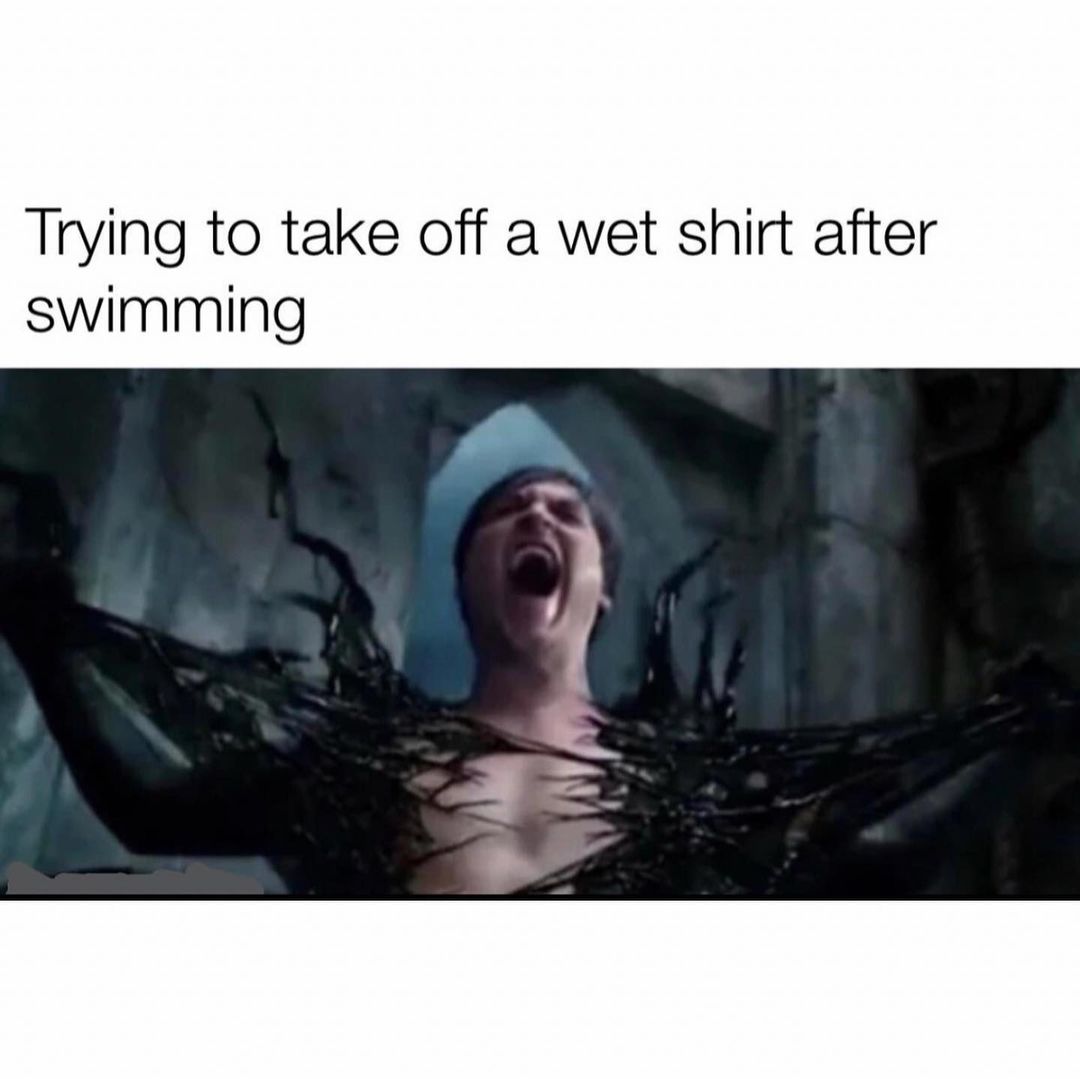 Trying to take off a wet shirt after swimming.